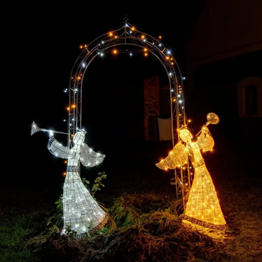 Two light-up angels with trumpets under an arch: ice white 3DA1 on the left, warm white 3DA1W on the right