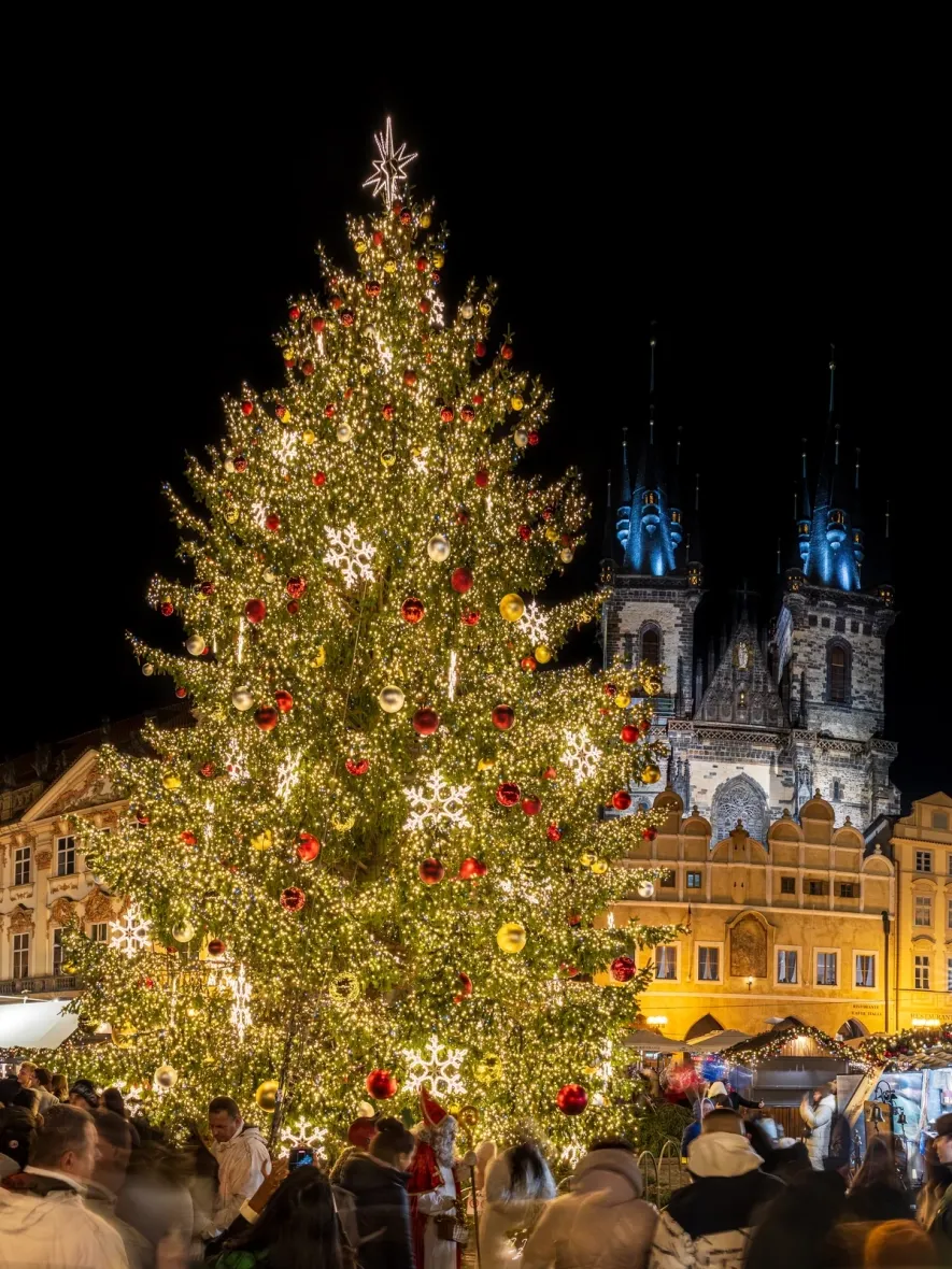 Christmas tree on Old Town Square in Prague with a topper, string lights and DECOLED snowflakes